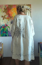 Load image into Gallery viewer, Side view of vintage tablecloth dress showing relaxed straight cut and uneven decorative hem