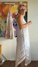 Load image into Gallery viewer, Front view of antique linen cutwork tablecloth top showing lyre motif and crochet yoke