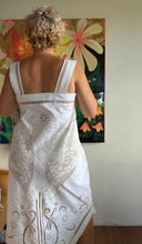 Load image into Gallery viewer, Side view of antique linen cutwork tablecloth top showing asymmetric hem