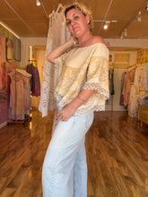 Load image into Gallery viewer, Front detail of antique linen tablecloth top showing embroidery and lace hem