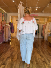 Load image into Gallery viewer, Back view of vintage linen tablecloth top showing scattered floral embroidery