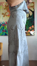 Load image into Gallery viewer, Side view of hand-dyed powder blue wide-leg pants with floral embroidery from vintage tablecloth