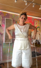 Load image into Gallery viewer, Model holding tie on hand-dyed ivory wrap top showing wrap silhouette and cropped length