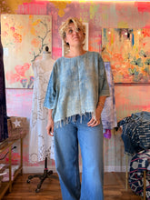 Load image into Gallery viewer, Front view of a loose lightweight indigo-dyed shirt with fringe hem, modeled indoors
