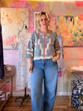 Load image into Gallery viewer, Front view of a soft thin West African indigo-dyed shirt with pink stripes and light geometric pattern, modeled indoors