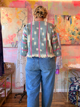 Load image into Gallery viewer, Back view of a soft thin West African indigo-dyed shirt with pink stripes and light geometric pattern, modeled indoors
