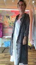 Load image into Gallery viewer, Close-up of the duster's chocolate-brown cutwork textile and embroidered floral motifs