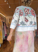 Load image into Gallery viewer, Back view of the boxy floral tablecloth shirt with a wide border along the hem and sleeves