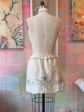 Load image into Gallery viewer, Front view of embroidered vintage linen tablecloth skirt with scalloped hem on dress form