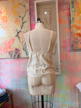 Load image into Gallery viewer, Back view of an ivory vintage tablecloth tank top with adjustable straps and dark scroll embroidery near the hem.